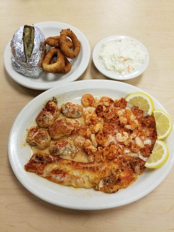 Broiled Alaskan white fish, shrimp and oysters with a baked potato and slaw