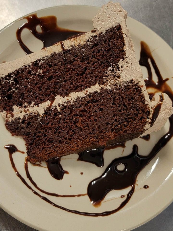Slice of homemade chocolate cake with chocolate drizzle