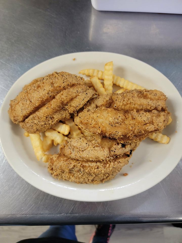 Fried catfish fillets over French fries
